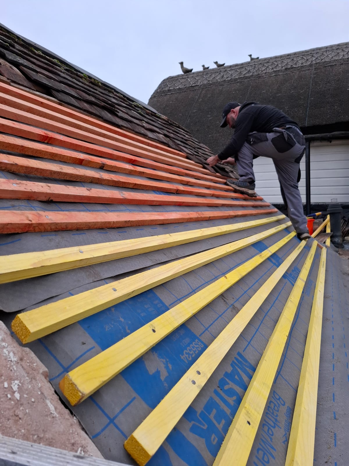 Membrane and batten installation across a pitched residential roof