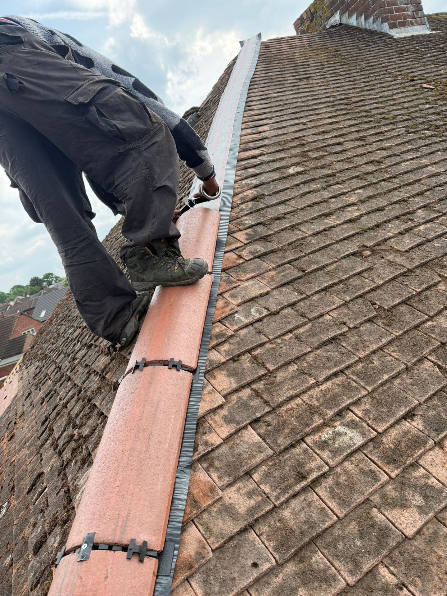 Roof Repairs & Maintenance in Worcester — Roofer re-bedding a clay ridge tile during a pitched roof repair in Worcestershire